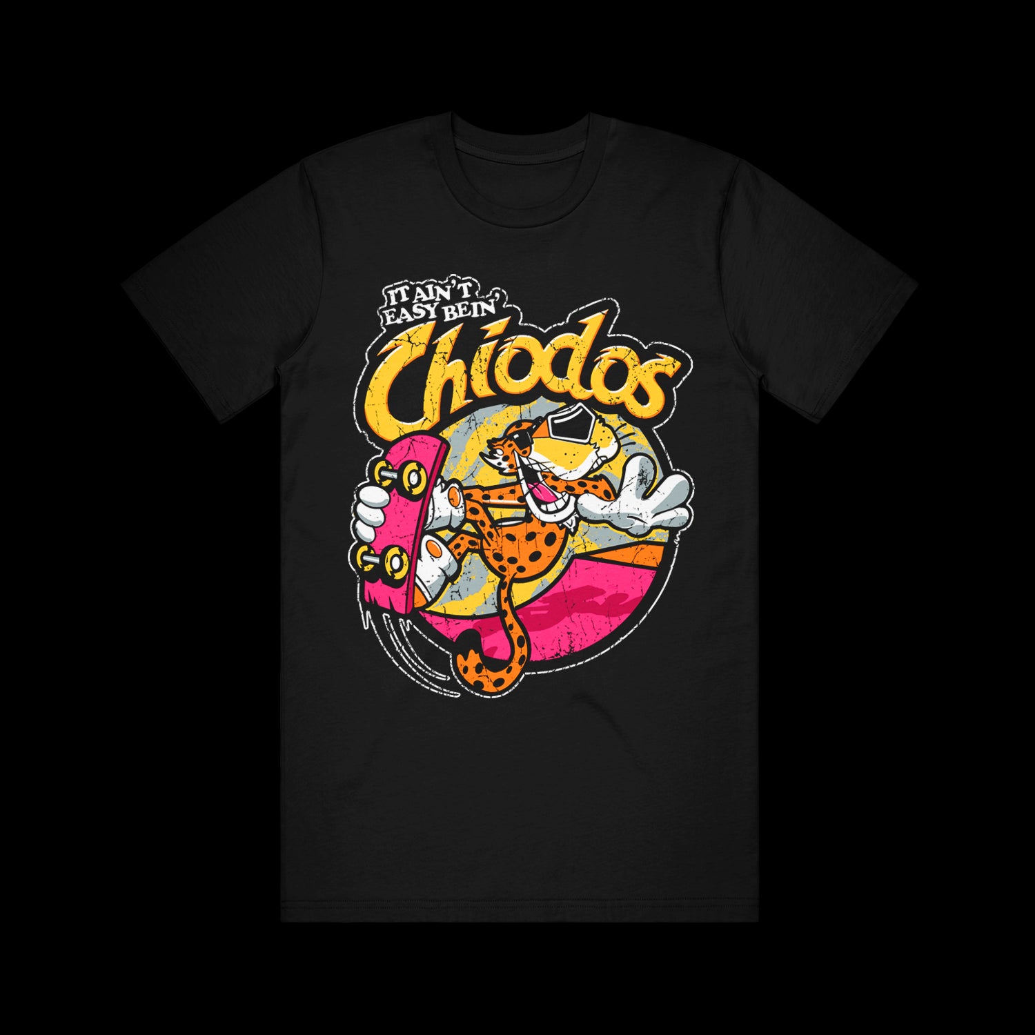 image of a black tee shirt on a white background. front of tee has center print that says it ain't easy bein' chiodos. an image of a the cheetos cheetah mascot on a skateboard is in the center